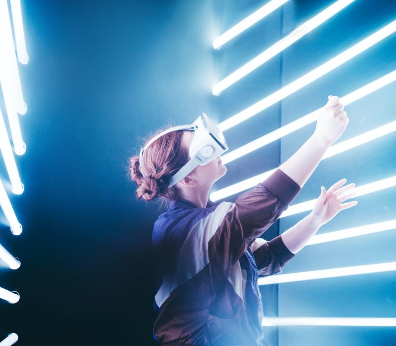 girl-using-vr-goggles-in-colorful-neon-lights